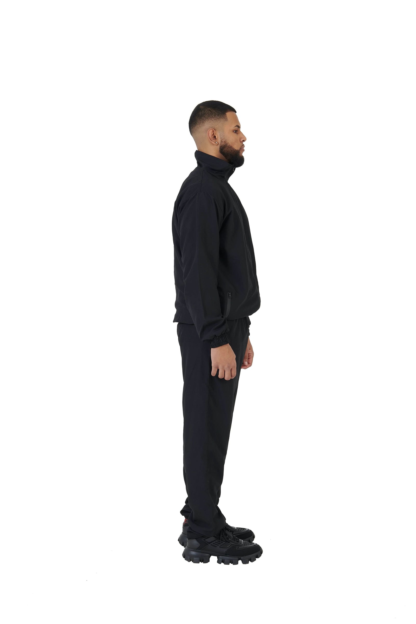 A wholesale supply of oversized nylon jackets with matching oversized nylon joggers is available.