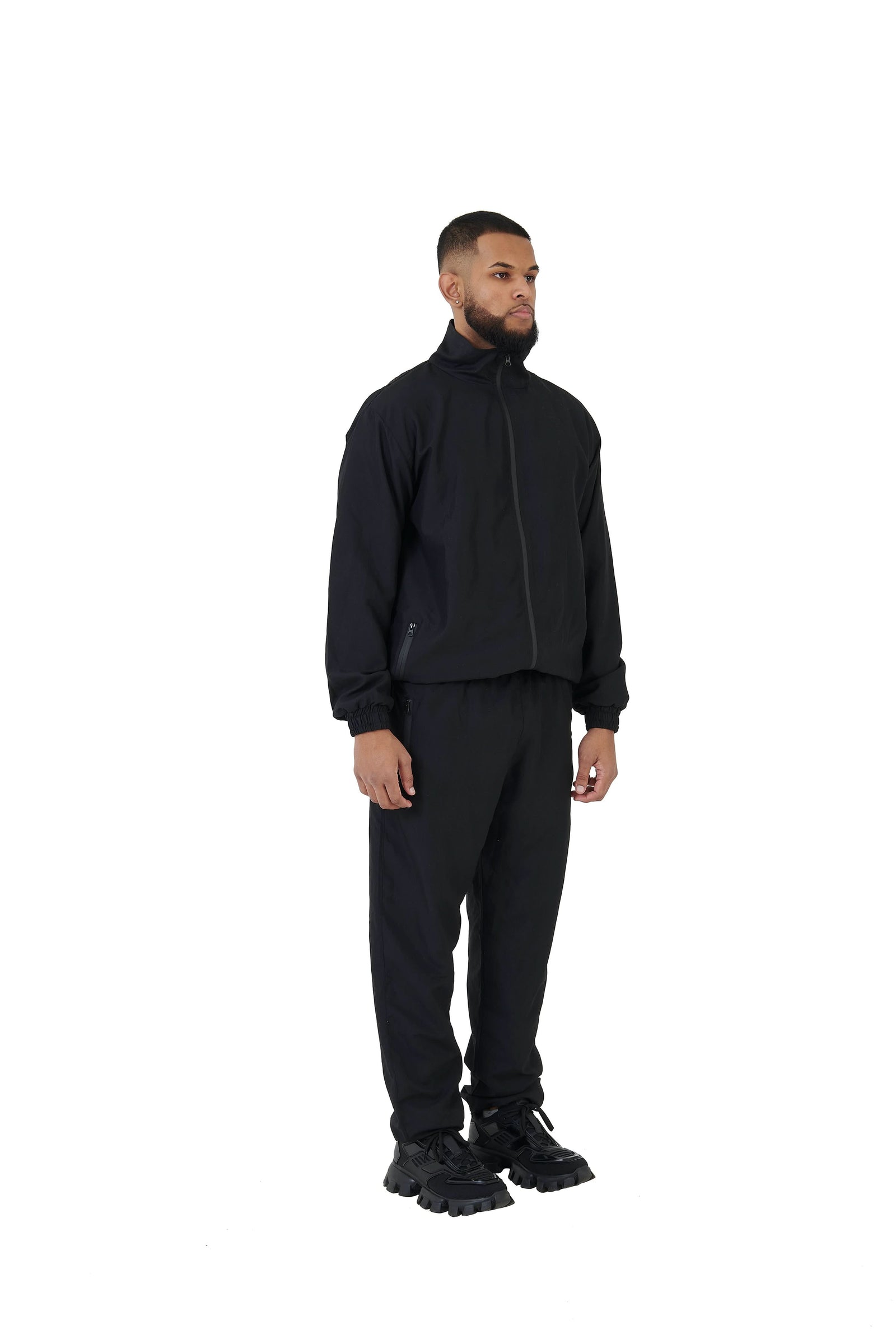 A wholesale supply of oversized nylon jackets with matching oversized nylon joggers is available.