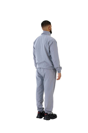 A wholesale supply of oversized nylon jackets with matching oversized nylon joggers is available.